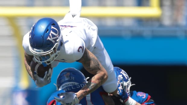 Kansas redshirt sophomore wide receiver Lawrence Arnold (2) jumps defenders during Saturday's spring game at David Booth Kansas Memorial Stadium.